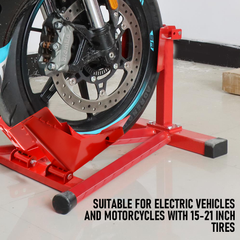 Red motorcycle wheel stand holding a motorcycle tire on a white floor.